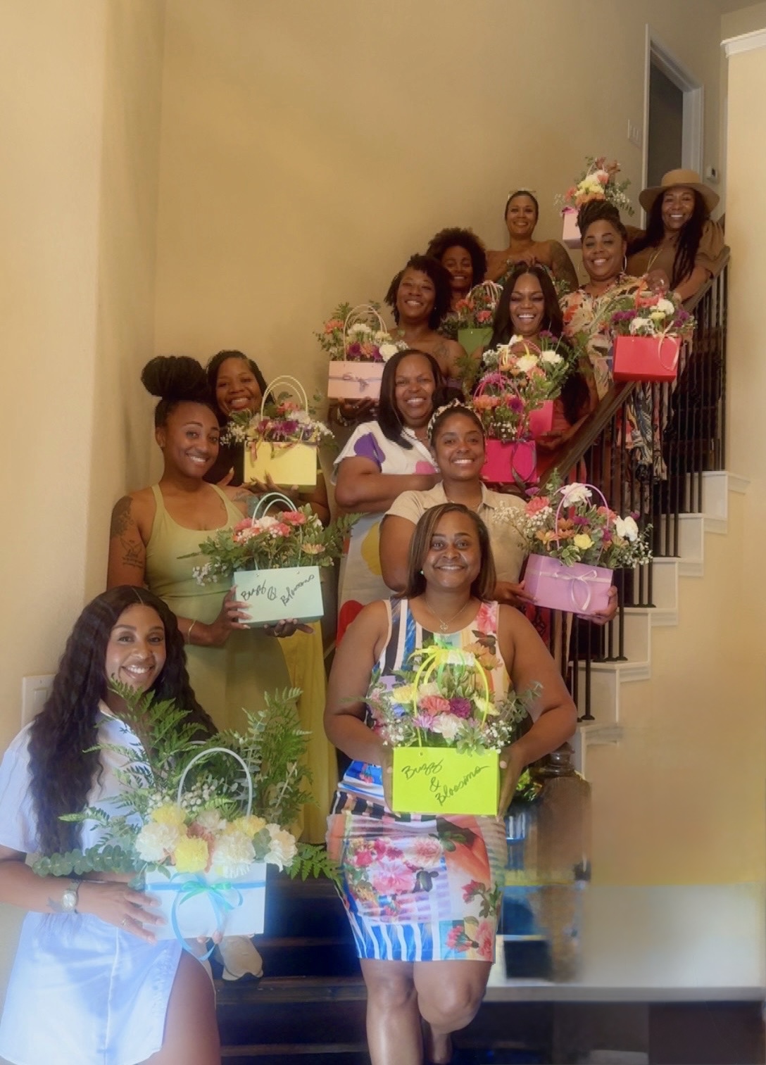 Group of guests on a staircase holding their finished bloom bag purses at a girls' afternoon brunch