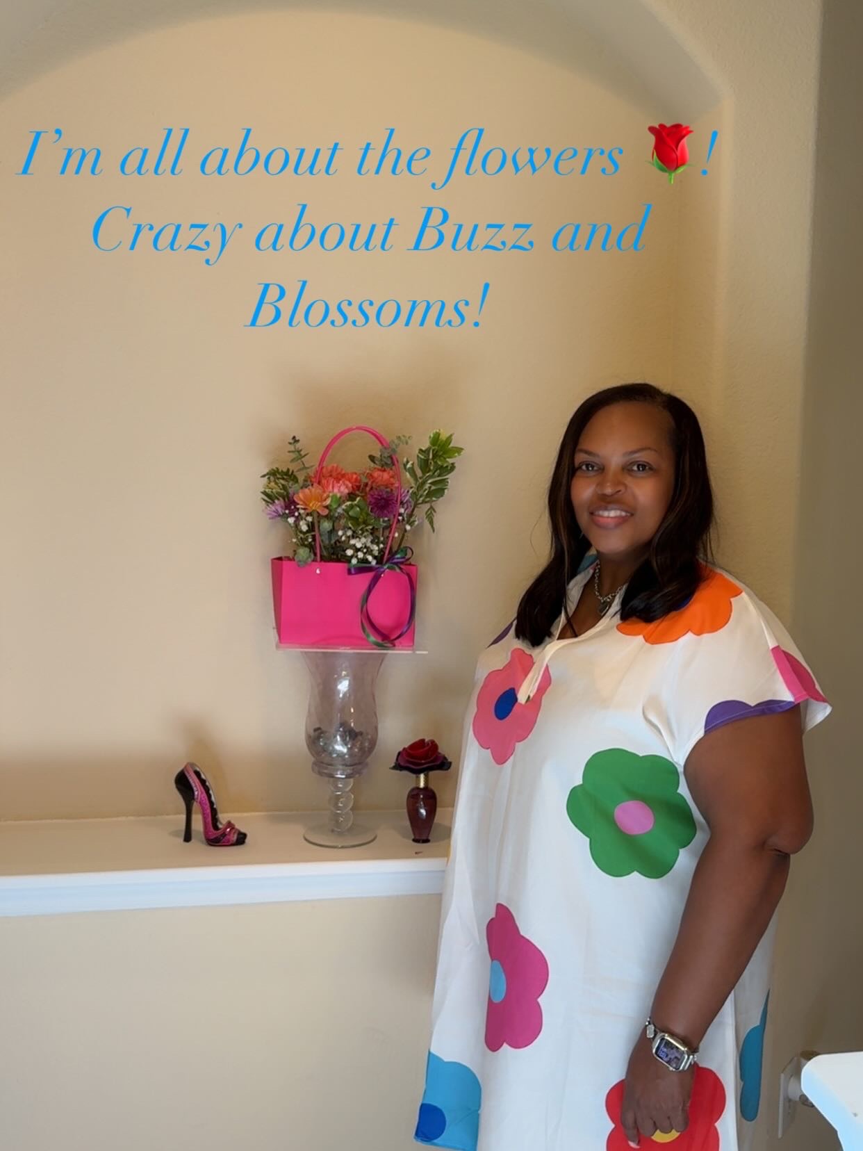 Guest in a bright floral dress beside her hot pink bloom bag purse arrangement at a girls' afternoon brunch